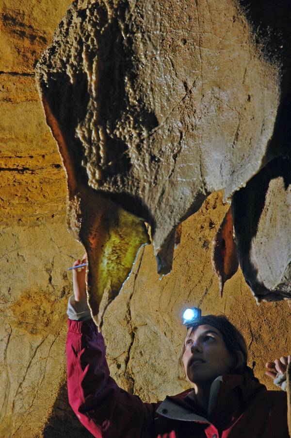 Researcher removing samples for dating from the Anthropomorph Chamber
