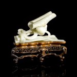 A Chinese celadon jade carving of a lotus, 17th–18th century, 14 cm.