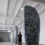 Jun Kaneko next to his Untitled, Dango, 2013, hand built glazed ceramics, 108.5 x 47 x 27 inches.