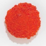 Lynda Benglis, Pi Tangerine, 2009, tinted polyurethane, 29 x 29 x 13.5 inches, ed. 1/3.